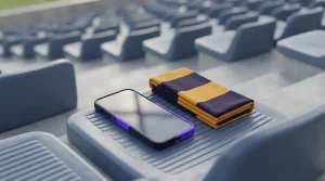 Smartphone auf einem Sitz der Stadiontribüne neben einem schlichten Sportschal